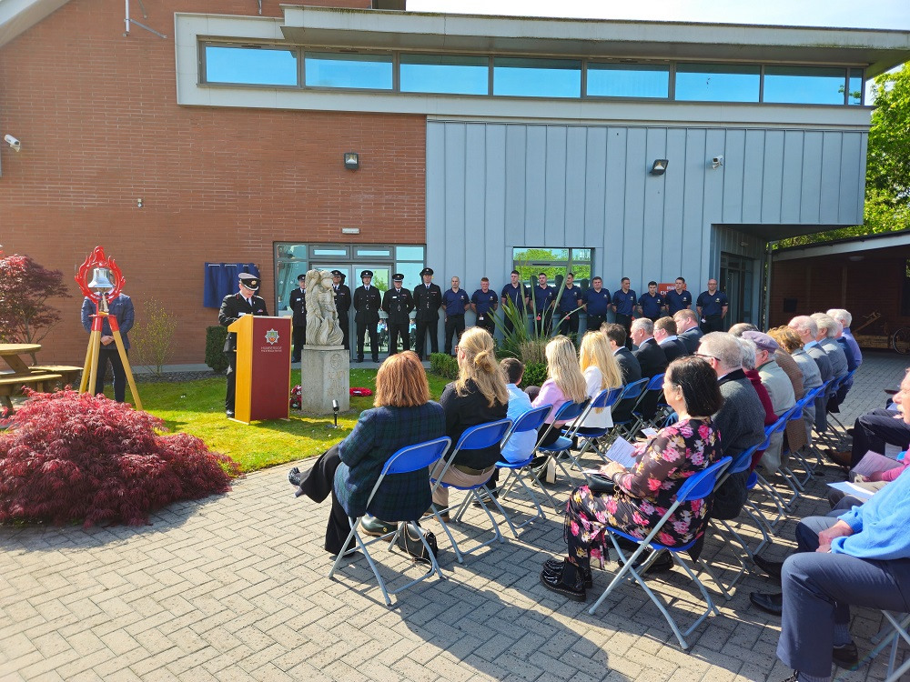 Guests and firefighters attend red plaque ceremony
